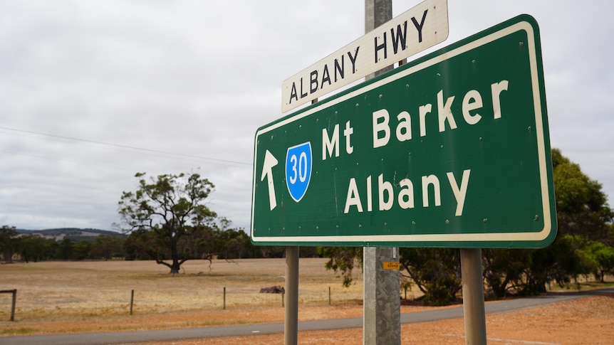 A road sign in the country indicating the way to Albany and Mount Barker.