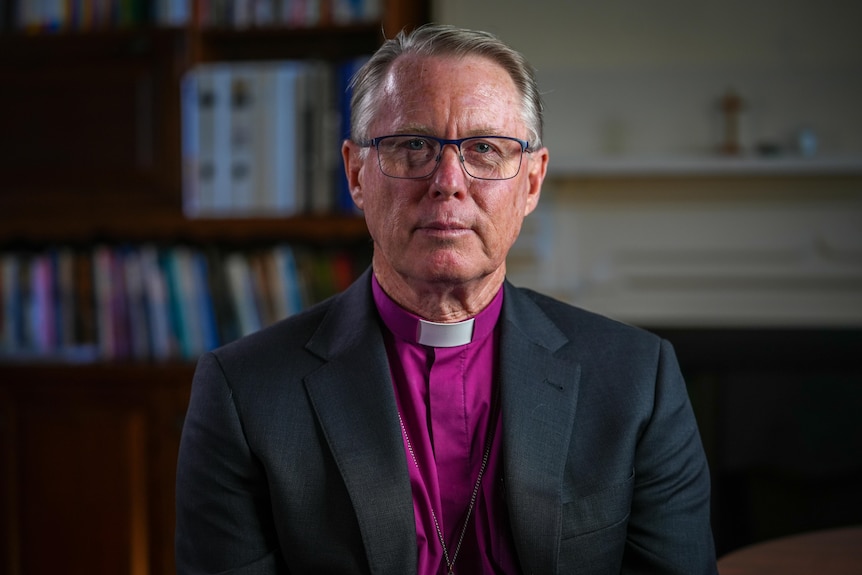 Portrait of archbishop Geoffrey Smith in purple shirt and black suit jacket