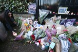 Fans lay flowers at the London home of late British singer George Michael