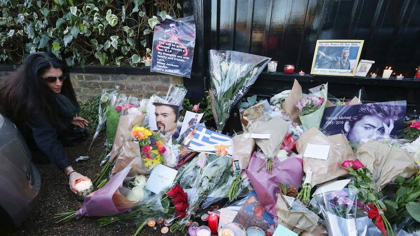 Fans lay flowers at the London home of late British singer George Michael