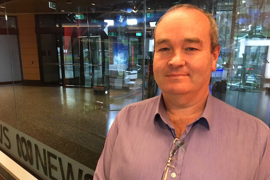 Jeff Bourman standing in front of the Melbourne ABC News TV studio