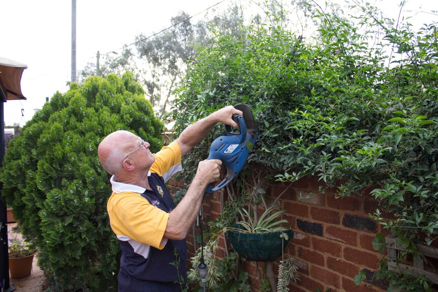 Goldfields Masonic Homes chairman Doug Daws trims the hedges at one of the resident's properties.