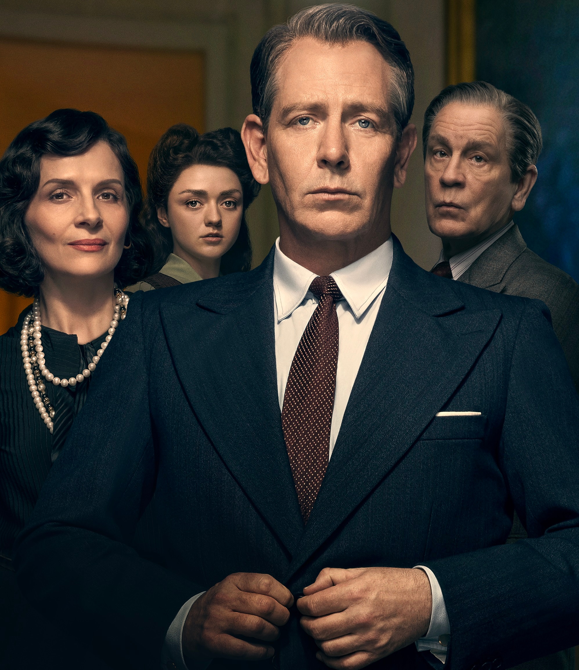 Ben Mendelsohn as Dior stands in front of Juliette Binoche as Coco Chanel, and Maisie Williams and John Malkovich in costume.