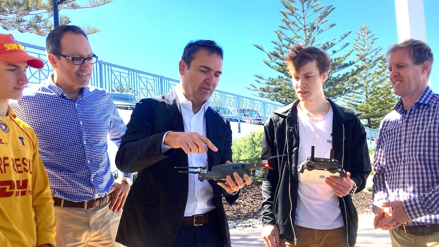 SA Liberal leader Steven Marshall holds a small drone.