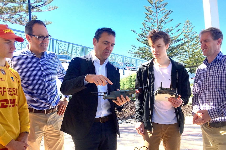 SA Liberal leader Steven Marshall holds a small drone.