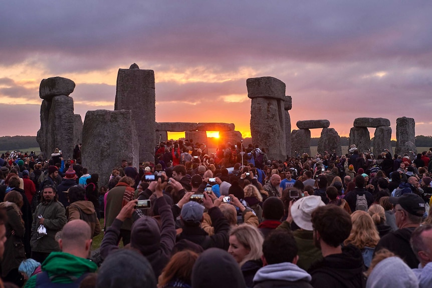 Revellers watch sunrise at Stonehenge