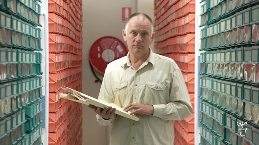 Man holding files in storage facility