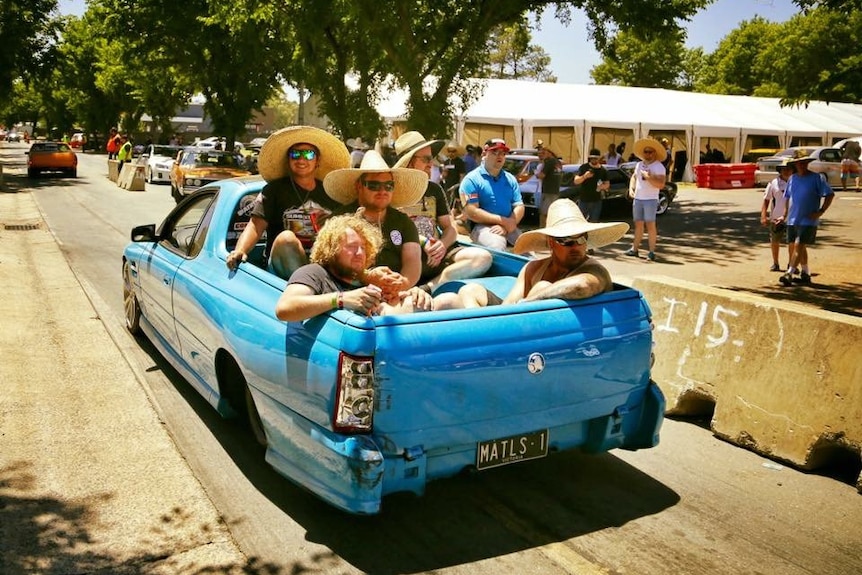 A group of men in the back of a ute