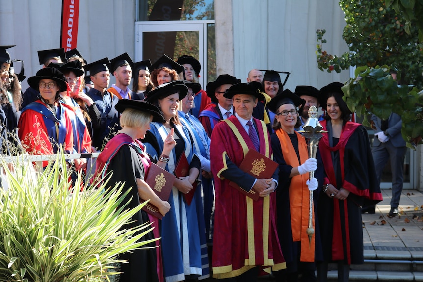 A group photo of people at a university graduation ceremony