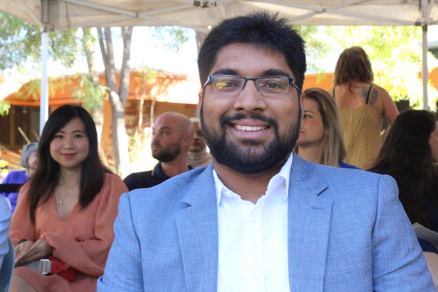 Seeni Mohammed sits excitedly waiting to receive his citizenship.