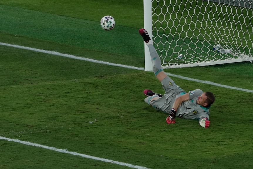 Sweden's Robin Olsen makes a save against Spain