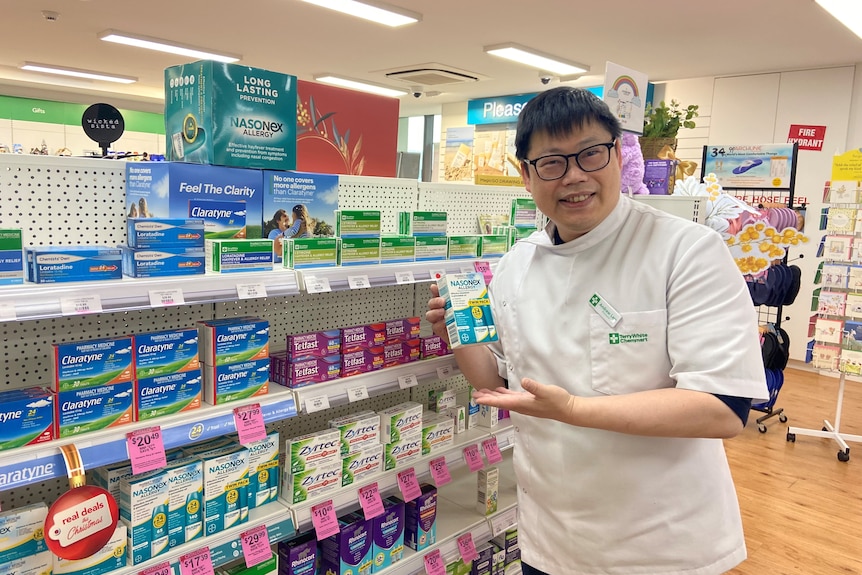 a photo of a pharmacist in front of hayfever medication 