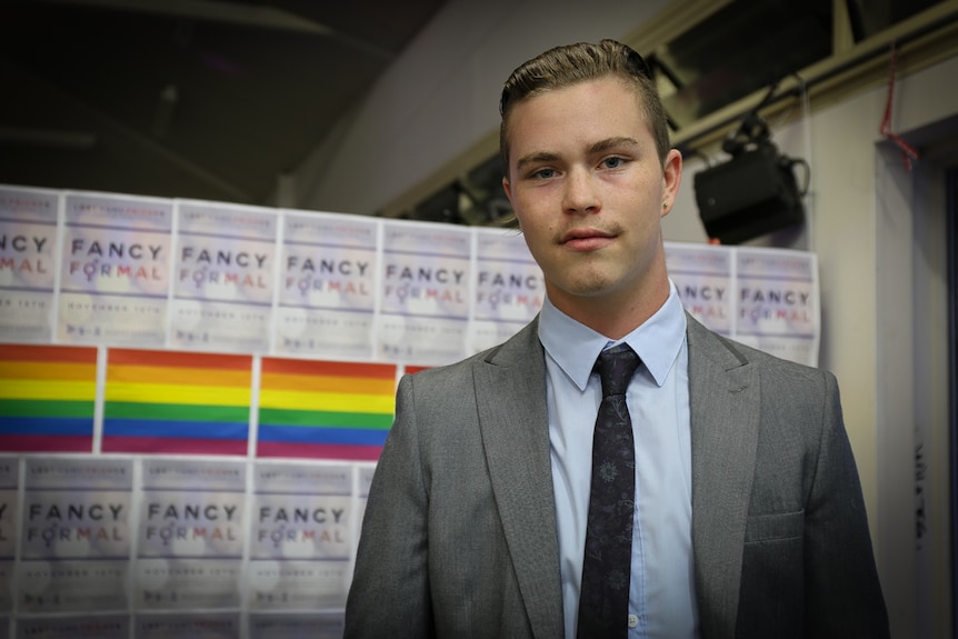 James Wright in front of Fancy Formal sign