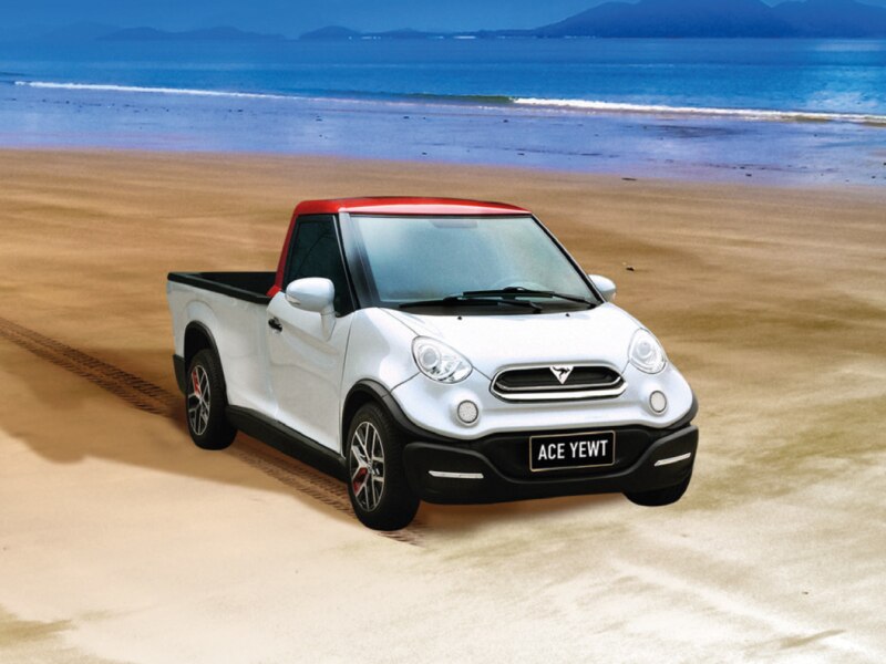 A small white utility vehicle. The number plate is black and says "ACE YEWT"