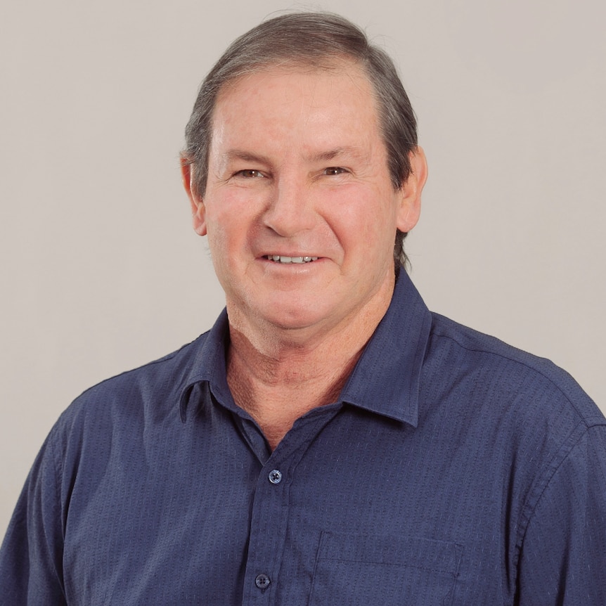 Man in blue business shirt, gently smiling