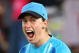 An Adelaide Strikers WBBL player celebrates taking a catch.