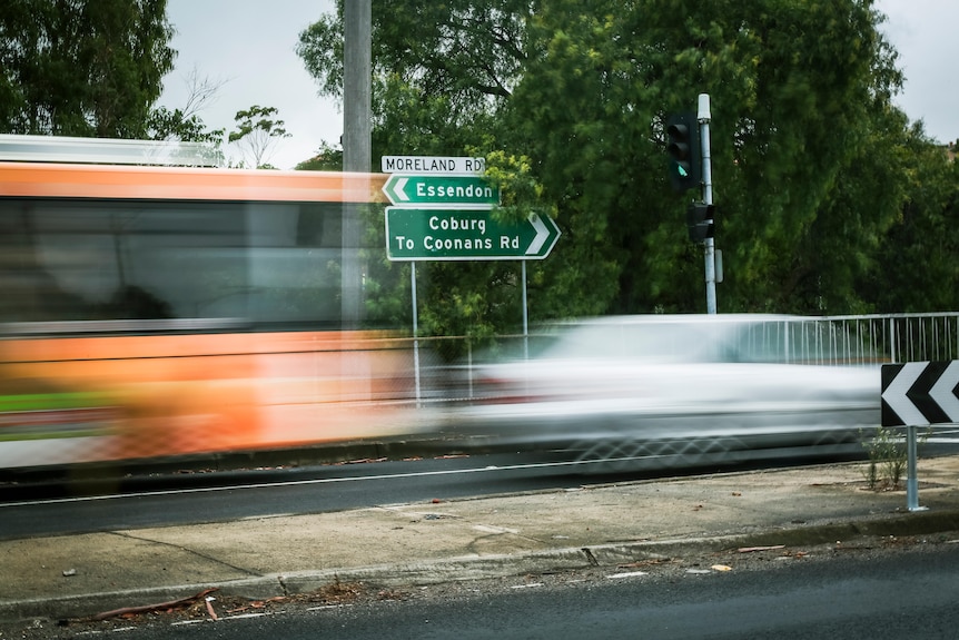Traffic drives past a street sign in Melbourne.