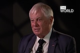 Hong Kong's last British governor, Chris Patten, speaks to the ABC's The World program. He is sitting in a studio.