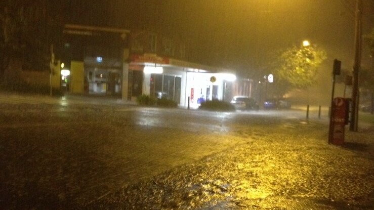 Rain flooding a Sydney sidewalk