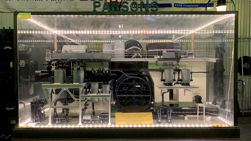 mechanic contraption inside glass case lit by LED lights in a museum