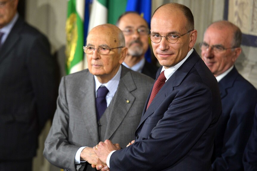 Italian prime minister-designate Enrico Letta (R) announces new government