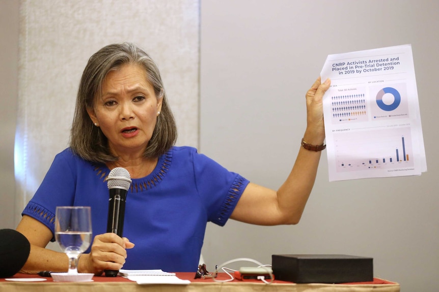 Mu Sochua, Vice President of the Cambodia National Rescue Party, holds up a piece of paper at a press conference in Jakarta.