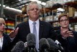 the prime minister holds his arms up amid a press conference