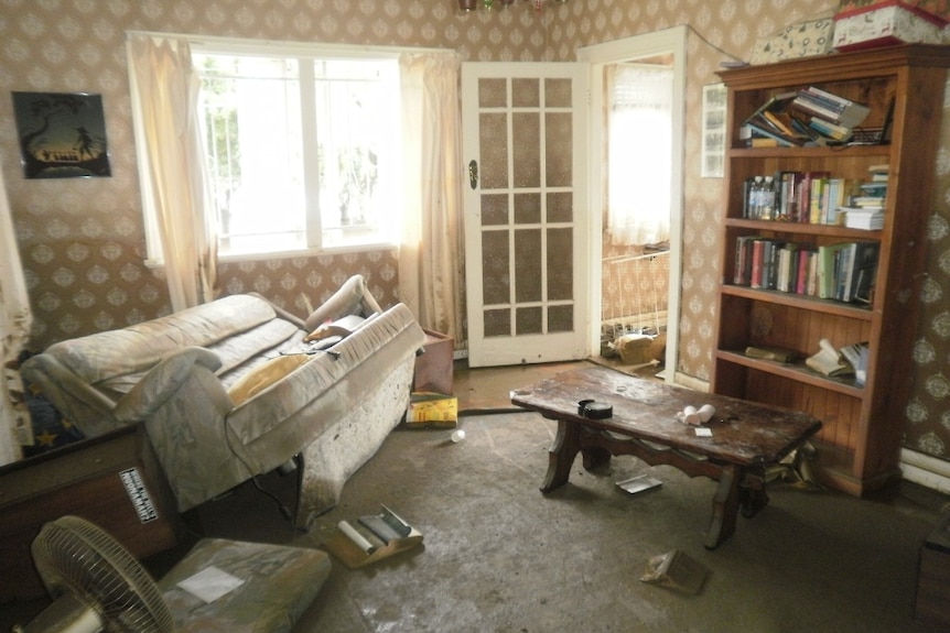 A Fairfield home's front room is covered in sticky, stinking mud.