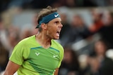 Rafael Nadal roars after winning a point at the French Open.