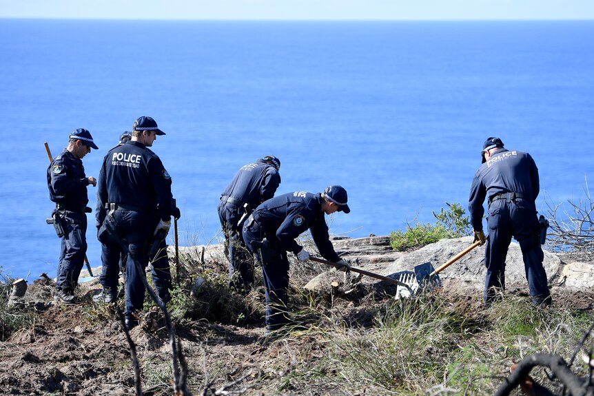 police conduct a search at a cliff