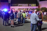 People stand at the scene of a stabbing in St Cloud, Minnesota
