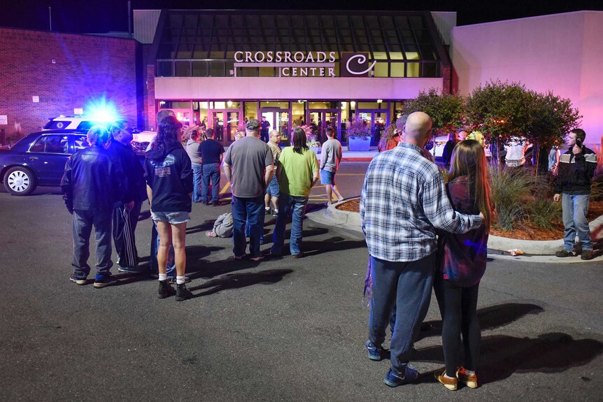 People stand at the scene of a stabbing in St Cloud, Minnesota