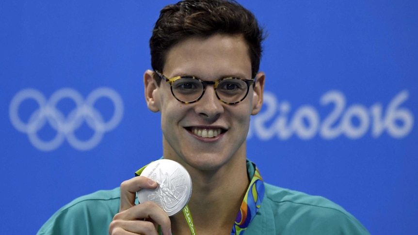 Mitchell Larkin poses with his silver medal for the men's 200 metre backstroke final.