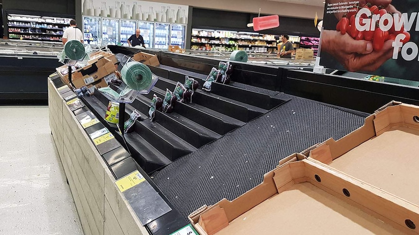 Empty fruit and vegetable shelves at a supermarket