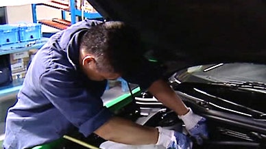 Man works on a car motor