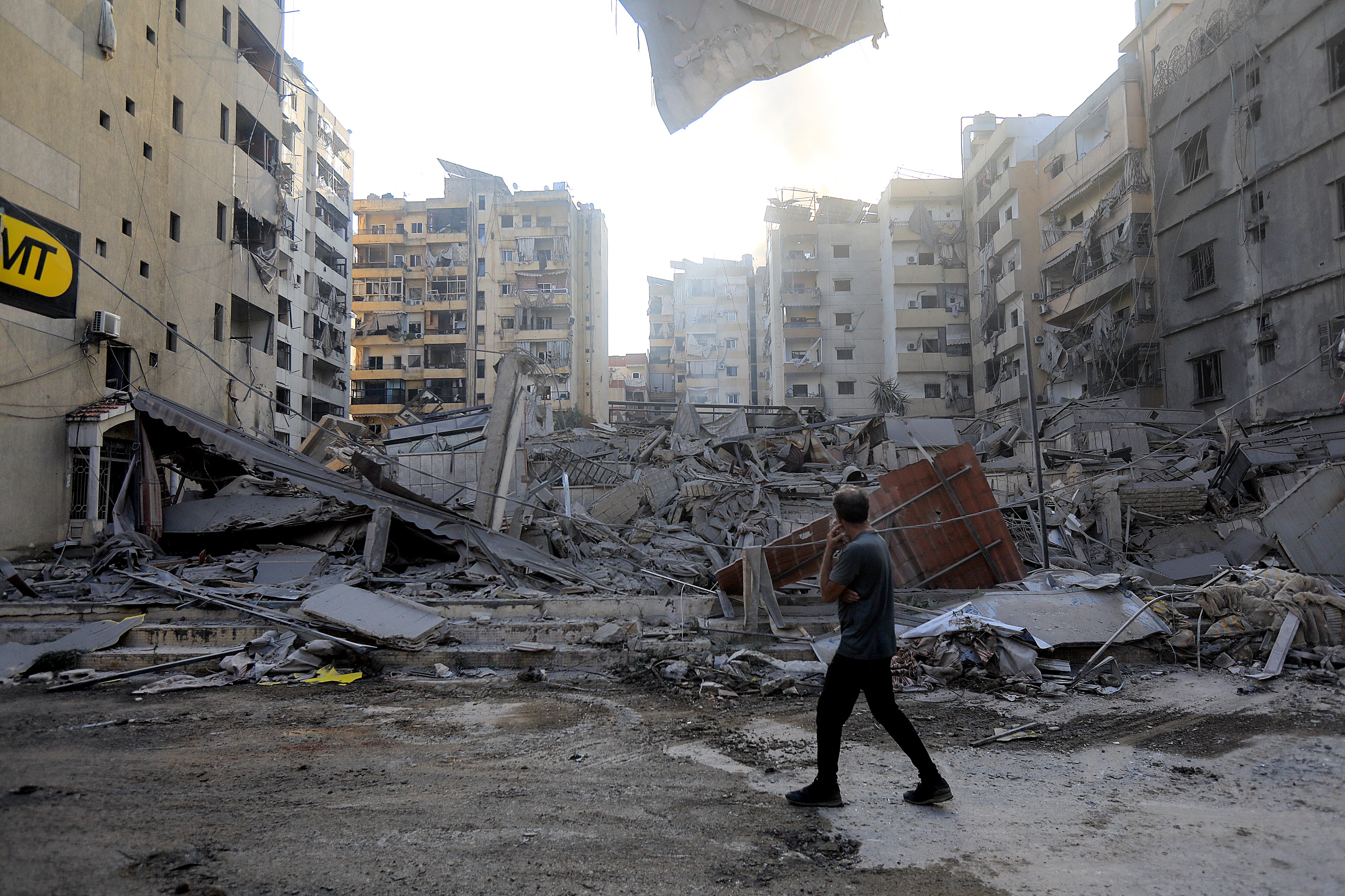 A man looks at the damage left by an Israeli strike in Beirut