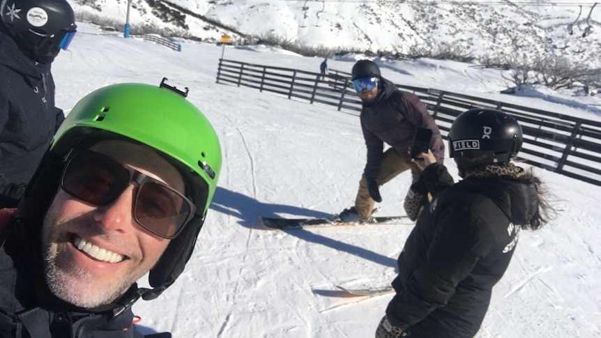 A man skiing with his friends.