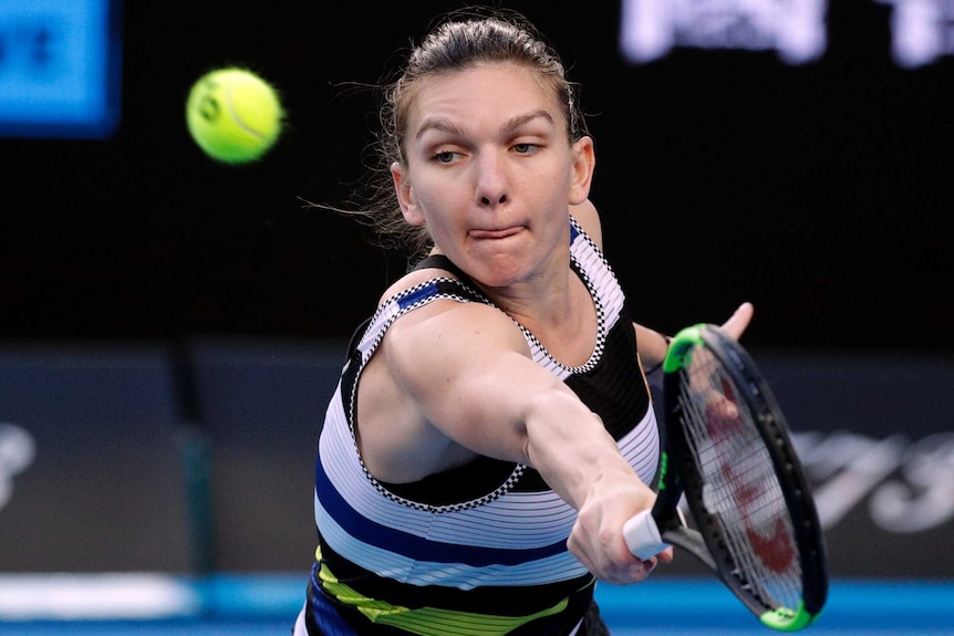 Simon Halep stretches to her left as she attempts a backhand return against Venus Williams.