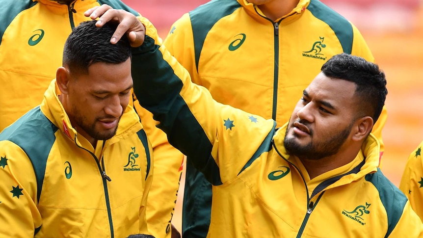 Israel Folau (left) and Taniela Tupou take their place in the Wallabies' team photograph ahead of the Test against South Africa.