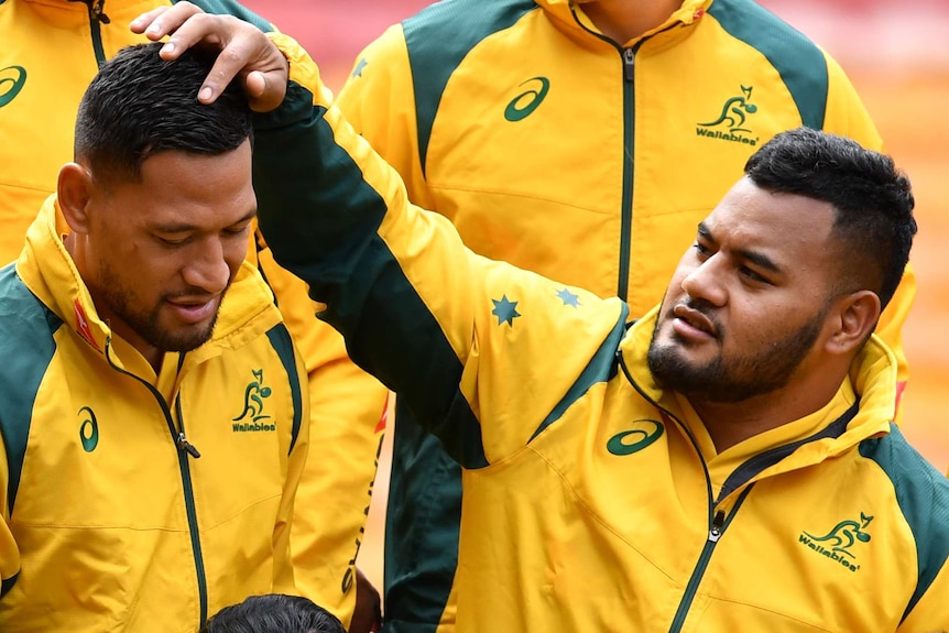 Israel Folau (left) and Taniela Tupou take their place in the Wallabies' team photograph ahead of the Test against South Africa.