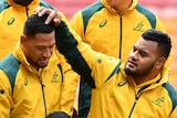 Israel Folau (left) and Taniela Tupou take their place in the Wallabies' team photograph ahead of the Test against South Africa.