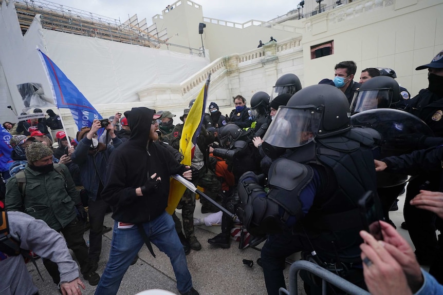 Donald Trump supporters try to break through a police barrier at the Capitol in Washington.