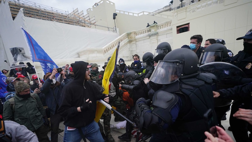 Donald Trump supporters try to break through a police barrier at the Capitol in Washington.