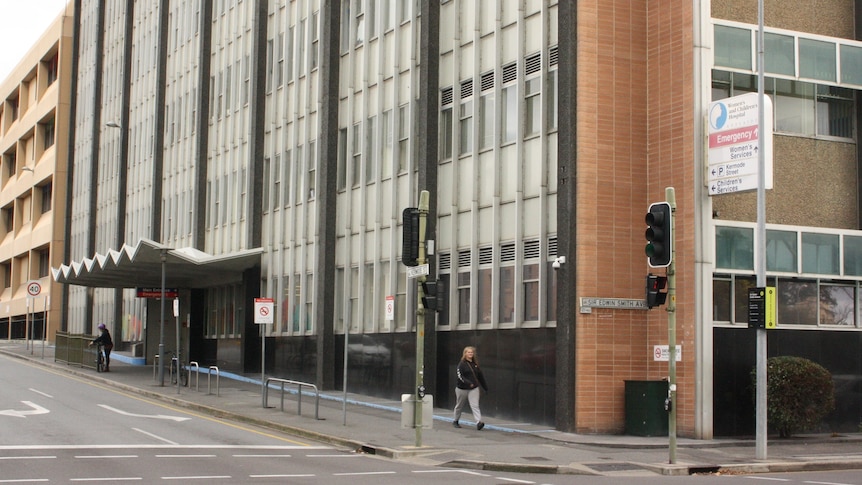 A large multi-storey building on a sloping city street