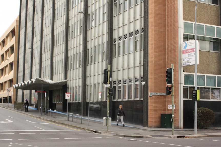 A large multi-storey building on a sloping city street