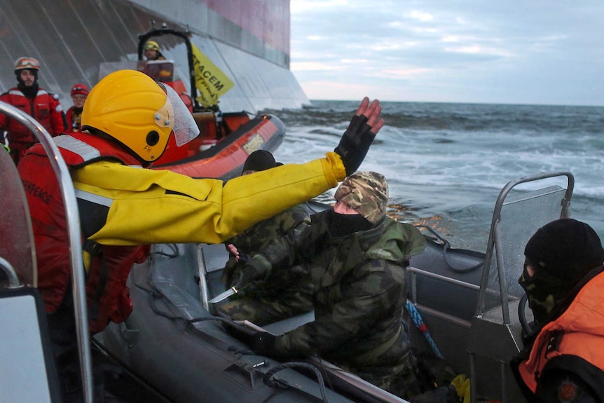 Russian border guards confront Greenpeace protesters