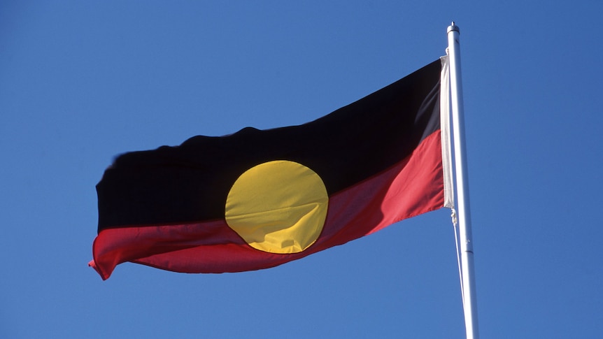 Aboriginal flag against blue sky