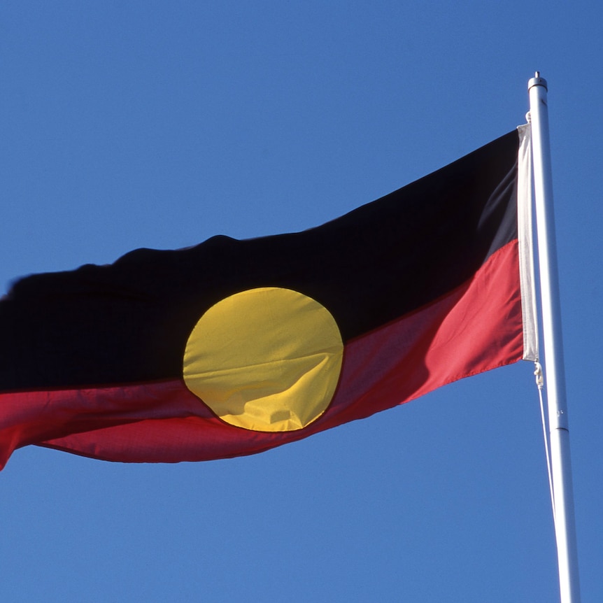 Aboriginal flag against blue sky