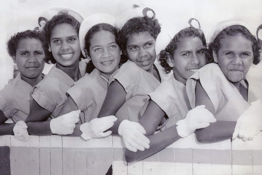 A black and white photo of six Cherbourg marching girls in a group photo in 1958.