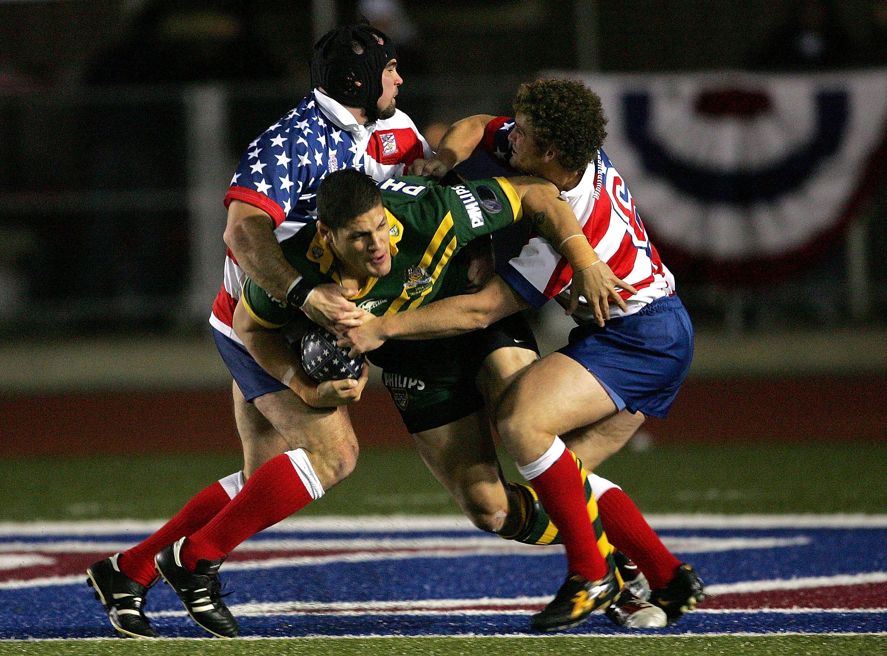 A man runs the ball during a rugby league match